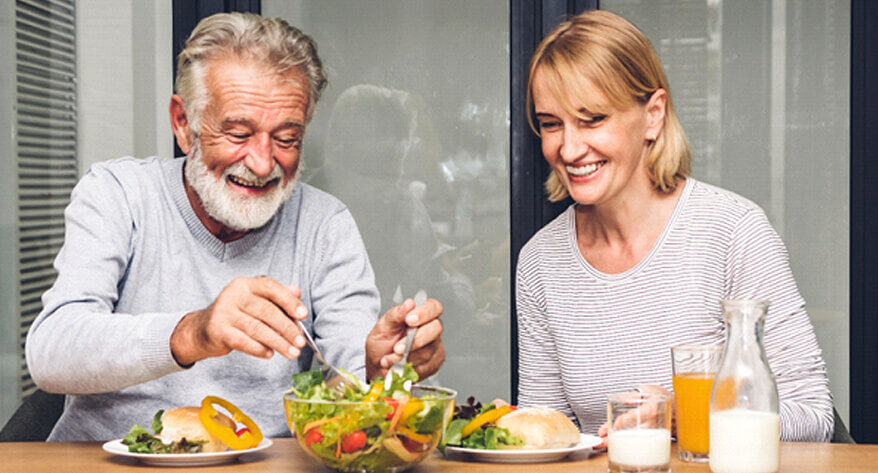 Happy couple with implant dentures